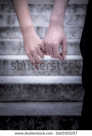 A couple holds hands while standing on a set of stairs.