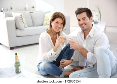 Couple At Home Celebrating New House Purchase