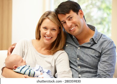 Couple At Home With New Baby