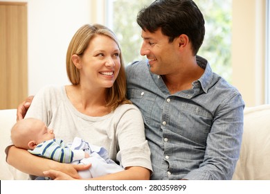 Couple At Home With New Baby