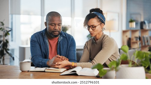 Couple, home and praying with bible for religion or spiritual guidance, belief and knowledge. Relationship, people and Christian with scripture or verse on holy book for worship, faith and gratitude