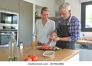 Couple at home preparing lunch in home kitchen