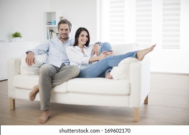 Couple At Home Relaxing In Sofa