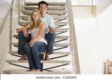 Couple at home sitting on stairs - Powered by Shutterstock