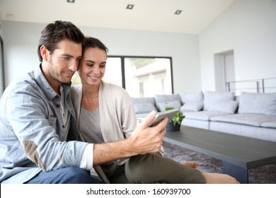 Couple at home websurfing on the net - Powered by Shutterstock