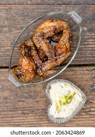 A Couple Of Honey Soy Flavored Wings In A Glass Platter Served With Ranch Dip In A Heart Shaped Bowl.