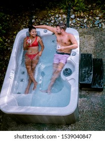 couple in hot tub bath in the rain forest of  Vancouver Island