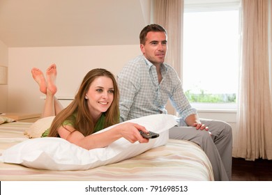 Couple In Hotel Room Watching TV