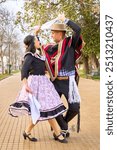 couple of huasos dancing Chilean cueca in the city square, Fiestas Patrias celebration 