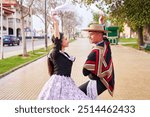 couple of huasos dancing Chilean cueca in the city square, Fiestas Patrias celebration 