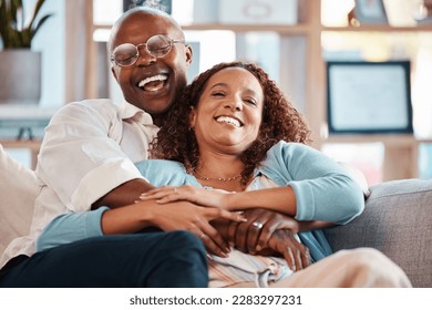 Couple, hug and laughing on sofa portrait in home living room, bonding and having fun. Interracial, love and funny black man and mature woman on couch embrace, relax and enjoying comedy together. - Powered by Shutterstock