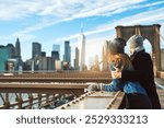 Couple, hug and view in city on vacation, honeymoon adventure and sightseeing on holiday. People, bridge and travel to New York with back on weekend, outdoor together and embrace for security on date