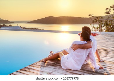 Couple in hug watching sunrise together in Greece - Powered by Shutterstock