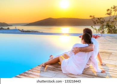 Couple in hug watching together sunrise in Greece