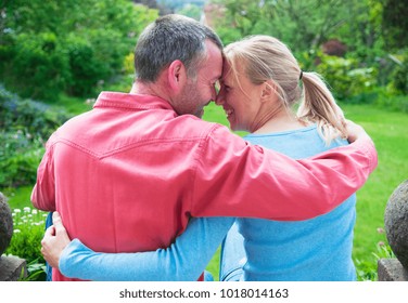 Couple Hugging In Backyard