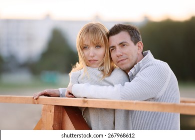 Couple Hugging And Looking Forward