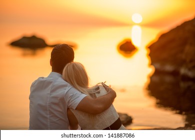 Couple Hugging On The Beach On Sunrise