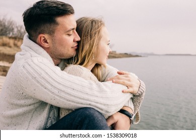 Couple Hugging On A Pier