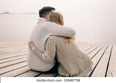 couple hugging on a pier - Shutterstock ID 550487758