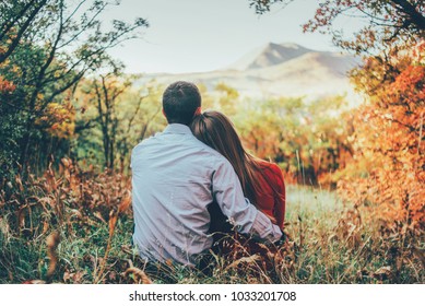 couple is hugging and sitting close in the forest  - Powered by Shutterstock