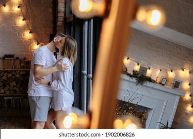 couple hugs on the background of a large window mirror and races