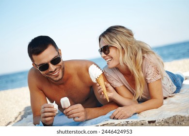 Couple, ice cream and beach for relax and travel outdoor for relationship and dating. Boyfriend, girlfriend or tourist with gelato dessert and smile by ocean for rest on towel in summer for holiday - Powered by Shutterstock