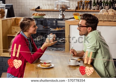 Couple interacting with each other while having coffee in cafeteria
