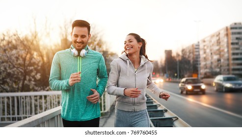 Couple jogging outdoors - Shutterstock ID 769760455