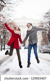 Couple Jumping In Snow