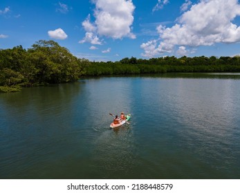 Couple In A Kayak In The Ocean Of Phuket Naka Island Thailand, Men And Woman In A Kayak At A Tropical Island With Palm Trees And Mangrove Forest. 