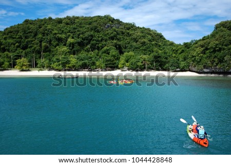 
Couple kayak through the waters of Ang Thong Thailand National Park