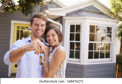 Couple With Keys Standing Outside New Home - Shutterstock ID 568476271