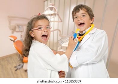 A couple of kids playing doctor at the dentist