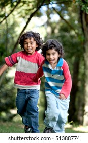 Couple Of Kids Running Outdoors And Having Fun