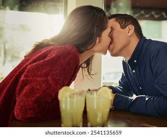 Couple, kiss and date with love at cafe for valentines day, romantic celebration and commitment. People, cocktail drink and support with relationship trust, loyalty and bonding together at restaurant - Powered by Shutterstock