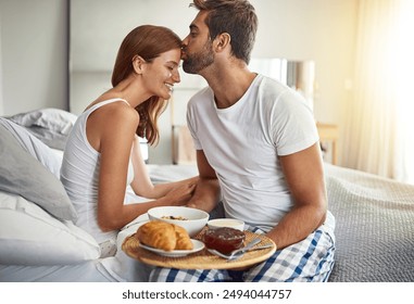 Couple, kiss and happy in bed for breakfast at hotel with room service for love and valentines day. Man, woman and, smile in morning in bedroom for support, food and celebration together on vacation - Powered by Shutterstock