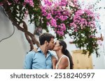 Couple, kiss and romance in city on holiday, marriage commitment and travel to Greece. People, outdoor date and support for security in relationship, bonding and together on honeymoon weekend trip