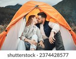 Couple, kiss and tent in camping on mountain for love, care or affection in nature together. Woman kissing man on camp site for romantic getaway, holiday vacation or weekend in outdoor bonding