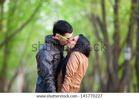 Couple kissing at alley in city.