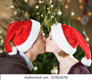 A Couple Kissing Beneath The Mistletoe