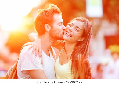 Couple kissing happiness fun. Interracial young couple embracing laughing on date. Caucasian man, Asian woman on Manhattan, New York City, USA. - Shutterstock ID 125302175