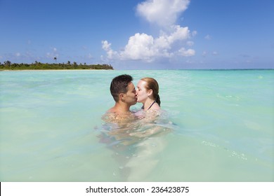 Couple Kissing On A Idyllic Beach At Riviera Maya, Mexico