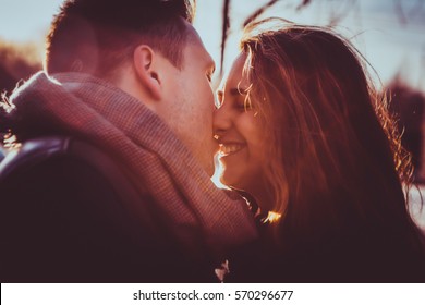 https://image.shutterstock.com/image-photo/couple-kissing-park-sunset-photo-260nw-570296677.jpg