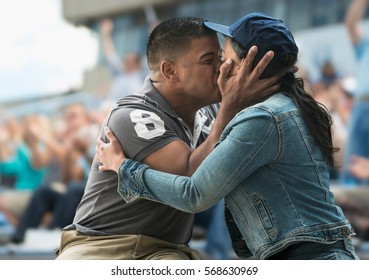 Couple Kissing At Sports Game