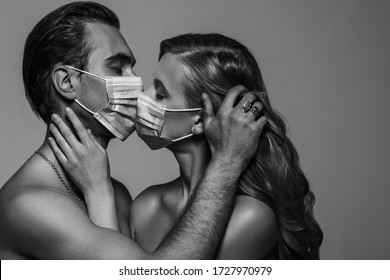 Couple kissing with surgical masks. Love during quarantine of coronavirus pandemic conception. Black and white, monochrome close up studio portrait. Copy, empty space for text