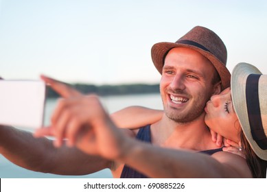 Couple Kissing And Taking Selfie At The Beach At Sunset, Golden Hour