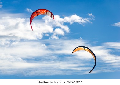 Couple Of Kitesurfing  Close Up High By The Bright Blue Sky Background