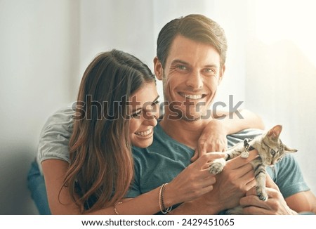 Couple, kitten and smile in home with care, hug and love for bonding with pet in living room. People, man and woman with kindness, portrait and excited for cat in lounge for animal adoption at house