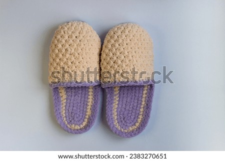 Couple knitted bootees isolated on white background. Hand-made slippers