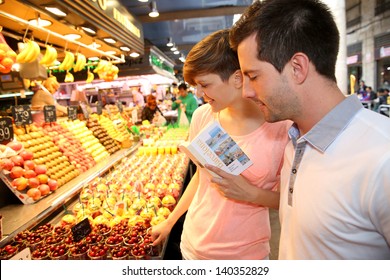 Couple In La Boqueria Market In Barcelona